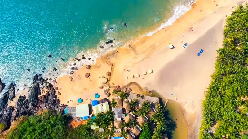 Aerial view of Palolem Beach with golden shoreline and Arabian Sea in Goa
