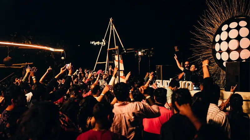 Travelers enjoying a vibrant beach party nightlife experience in Goa
