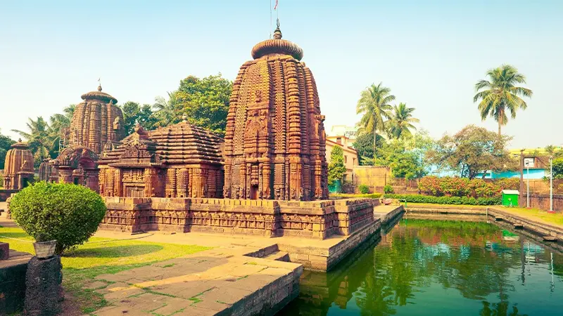 Historic temple ensemble reflected beside a traditional water tank