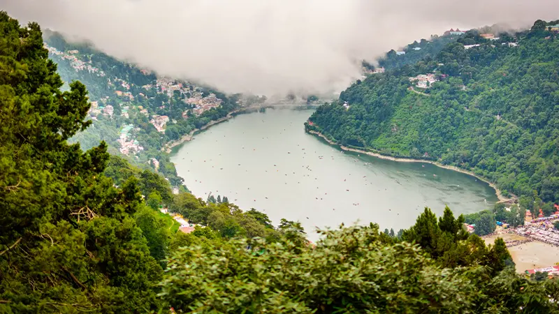 Aerial view of a scenic mountain lake surrounded by dense forests