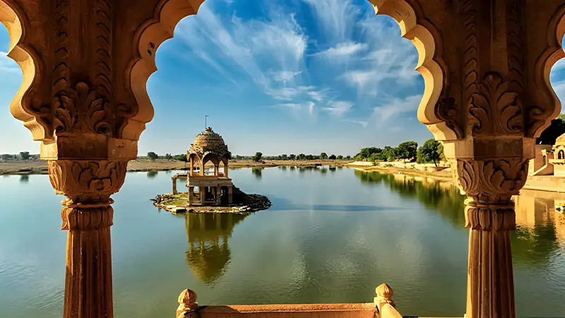 Historic pavilion and tranquil waters of Gadisar Lake in Jaisalmer