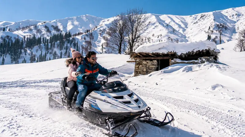 Couple enjoying snowmobile ride in Gulmarg