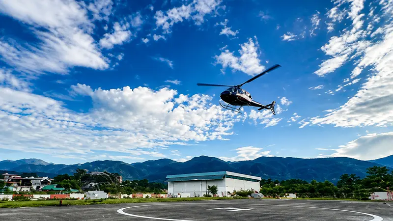 Helicopter taking off from a helipad in Uttarakhand